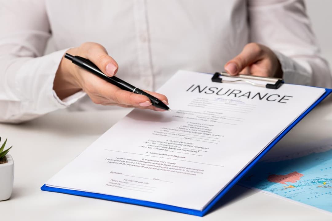 Insurance agent reviewing policy form with client